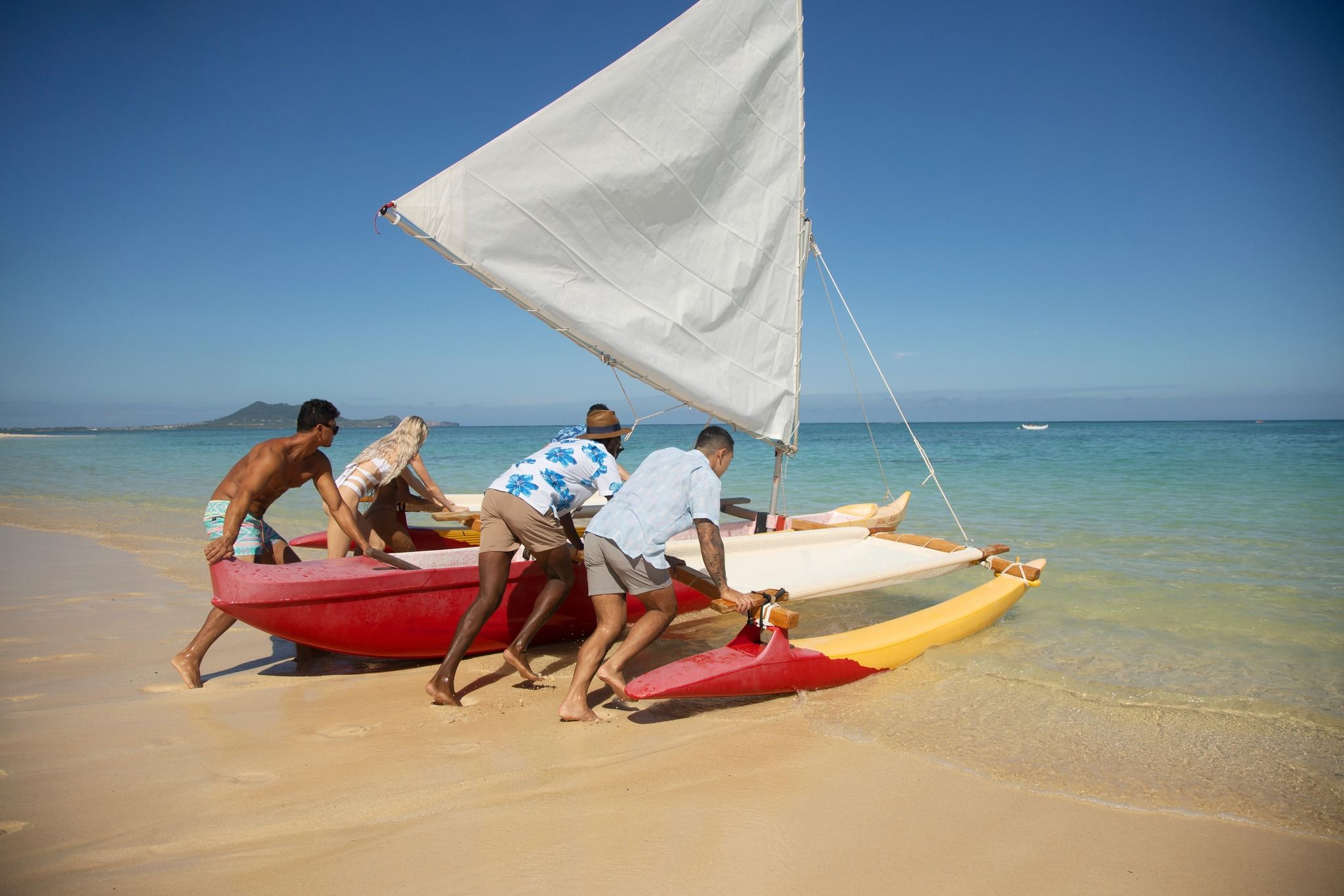 Men wearing Chubbies shorts, pushing boat into water