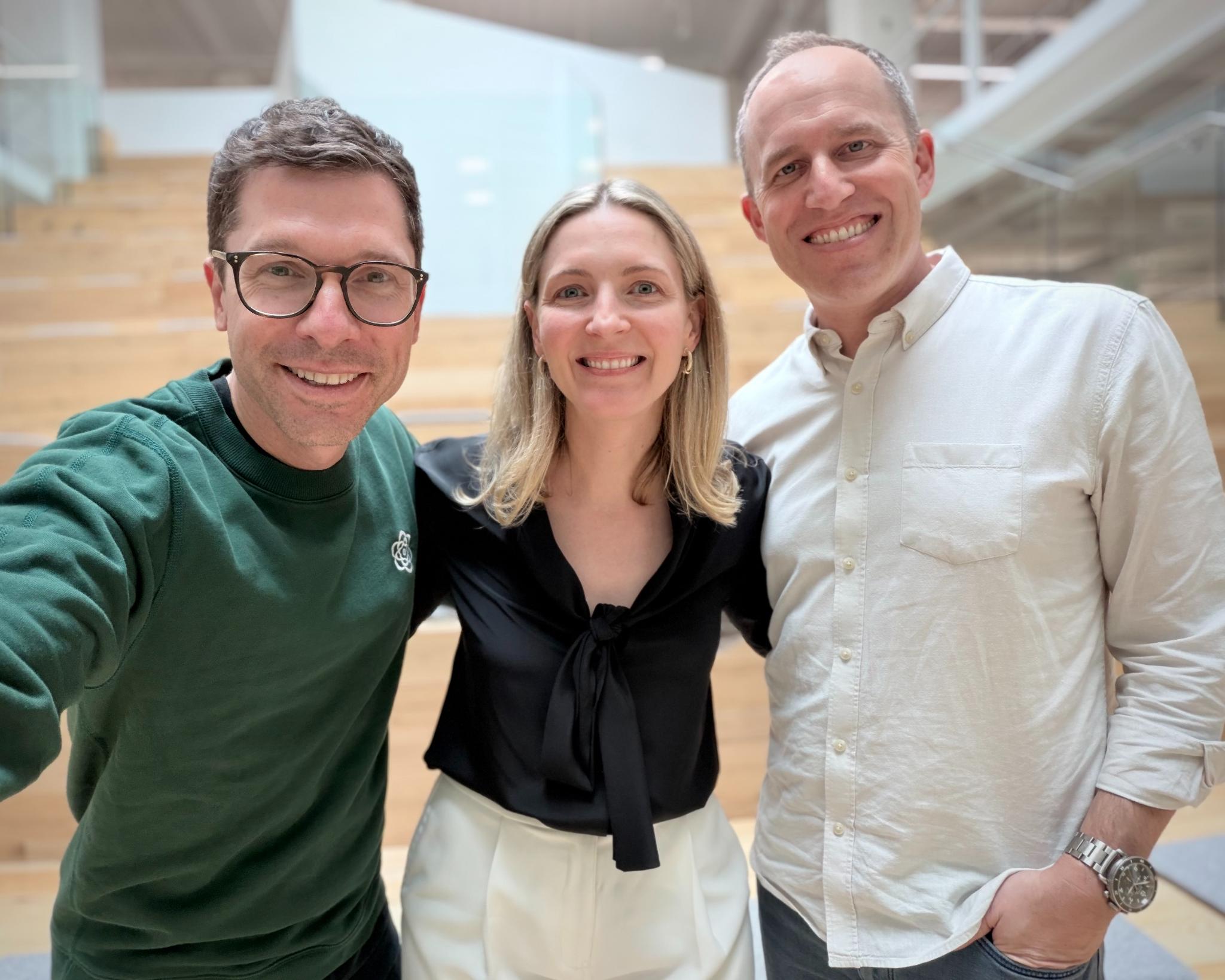 Three people smile in a selfie
