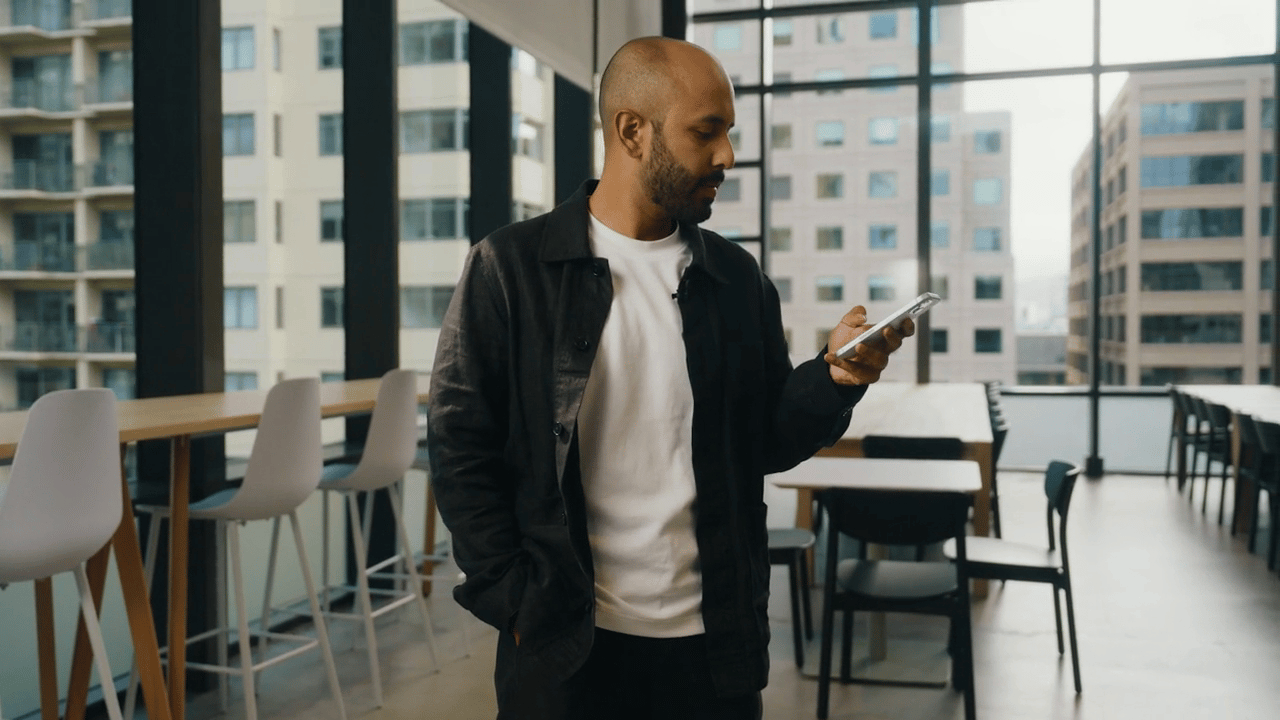 Man holding phone in an office