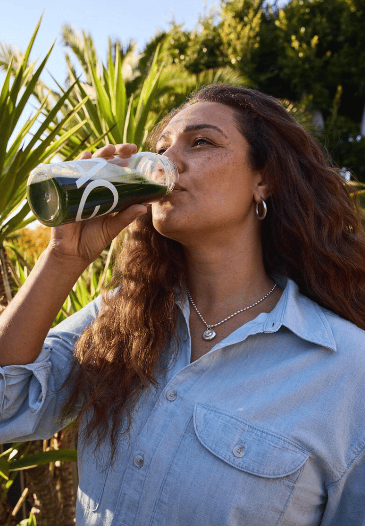 Woman drinking AG1