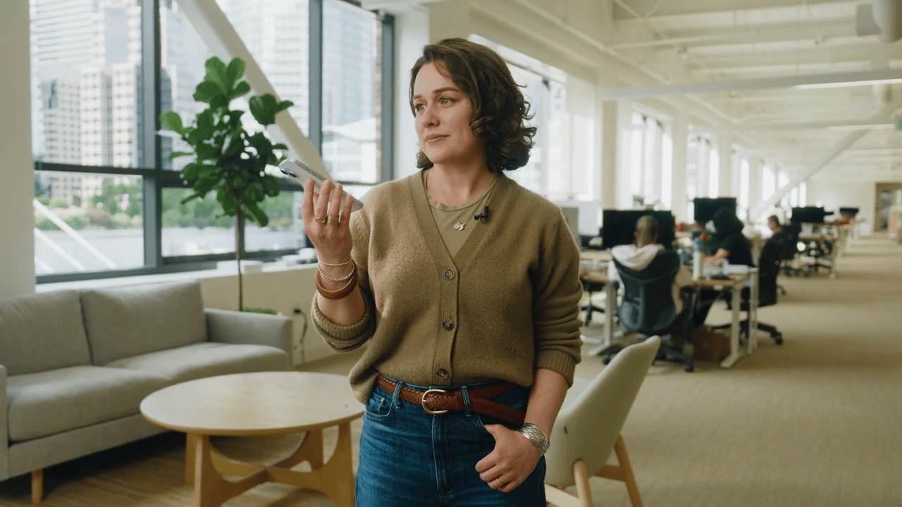 Woman holding phone in an office