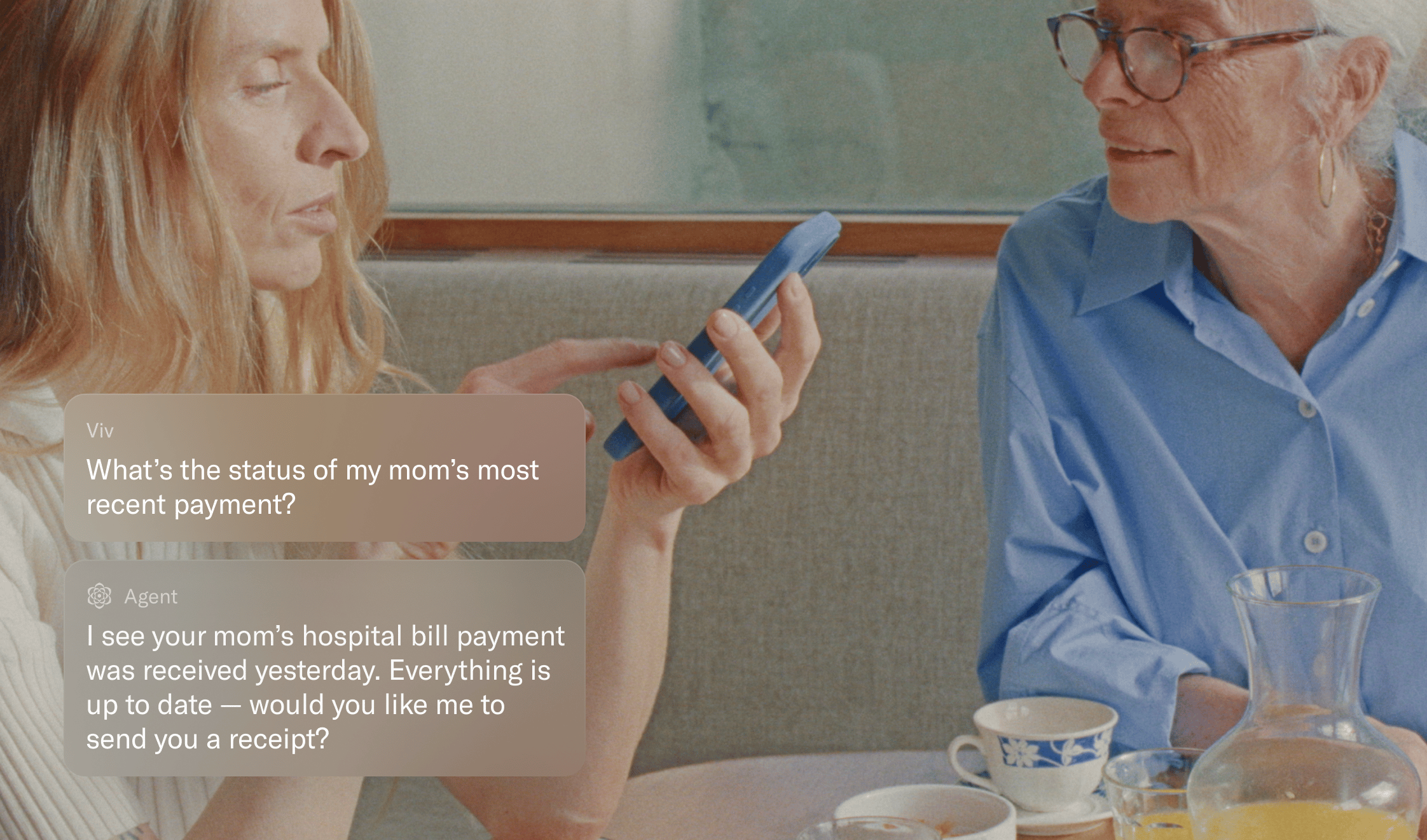 Woman helping older mother check on payment status via AI agent