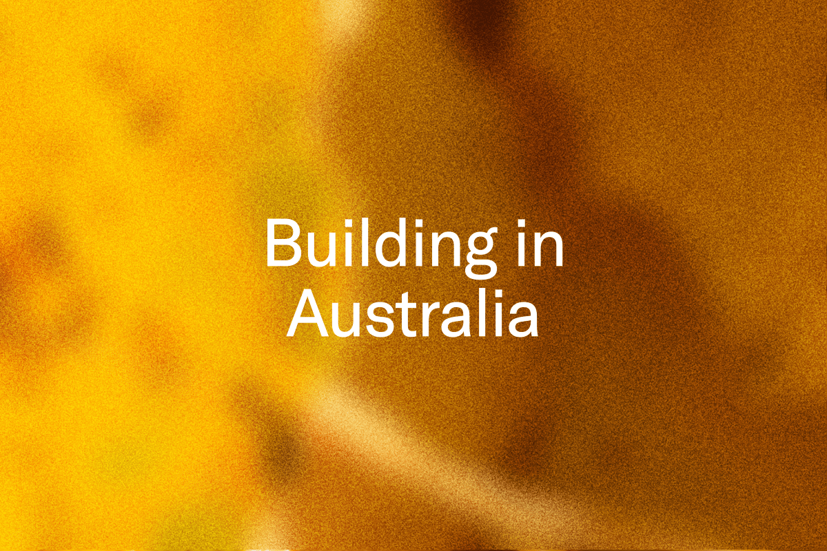 Text that reads "Building in Australia" on a blurred orange and brown background.