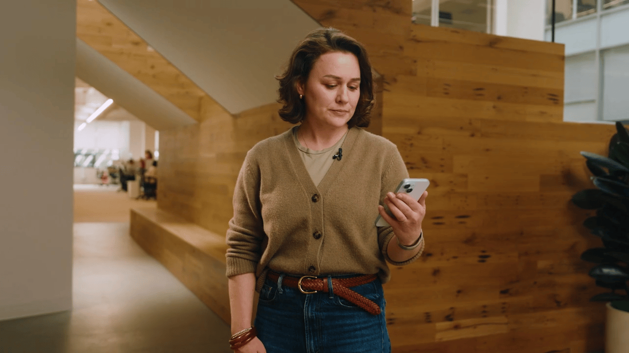 woman holding phone in an office
