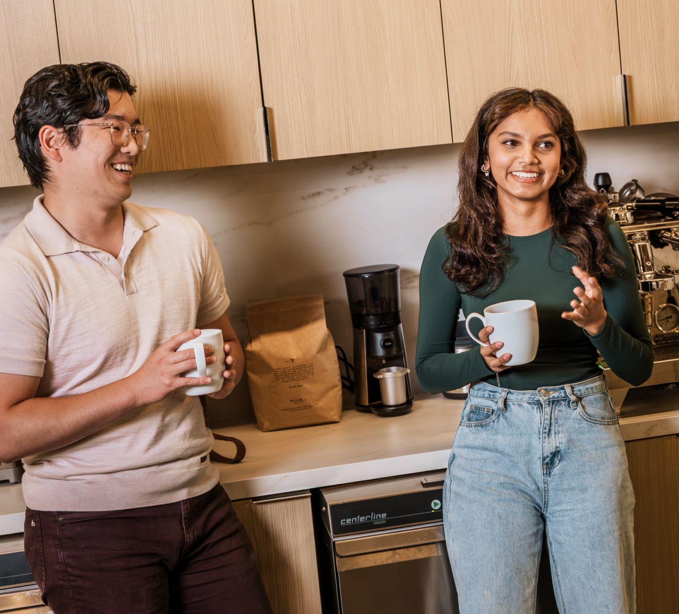 co workers chatting in the kitchen with coffee