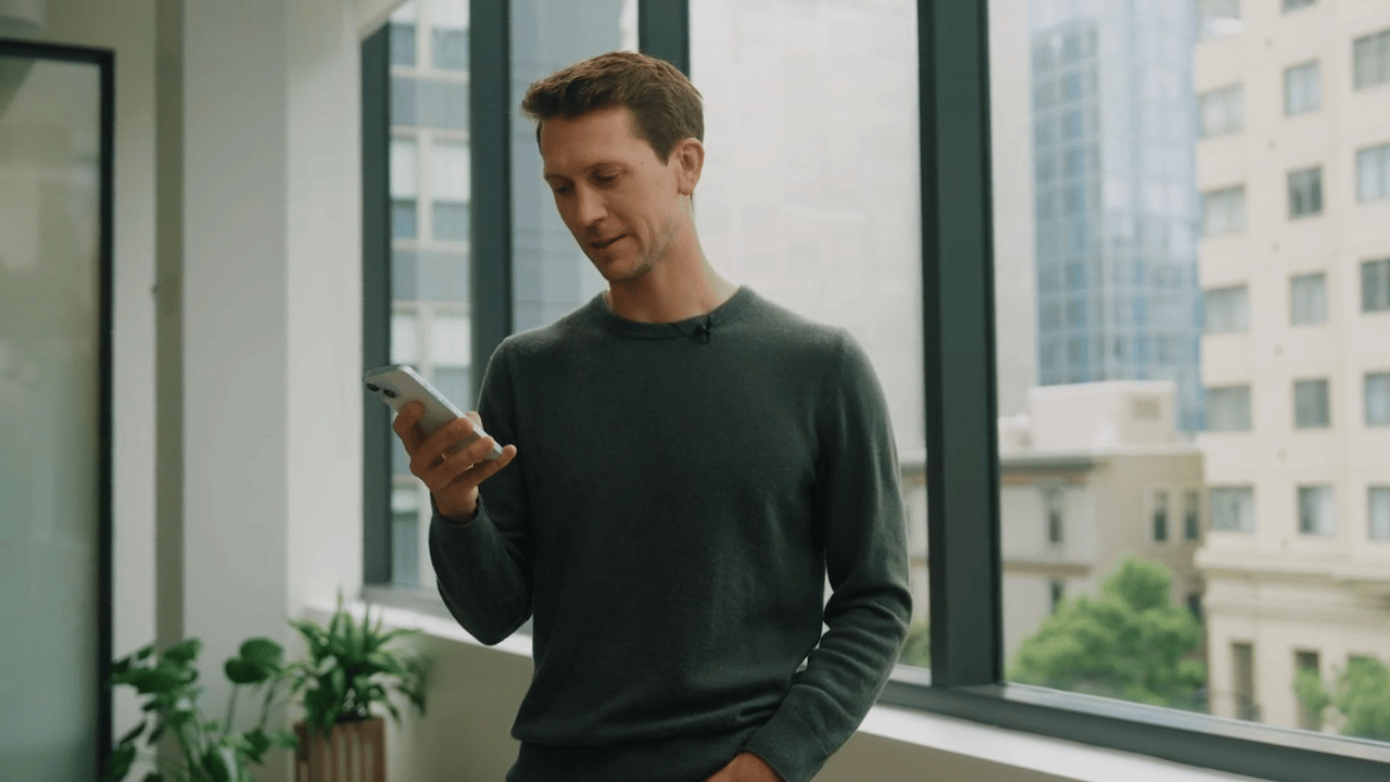man holding a phone in an office