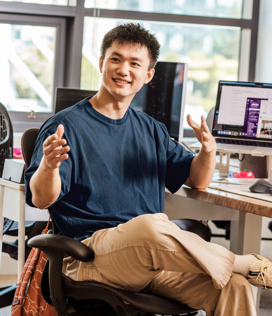 a man at his desk having an animated conversation