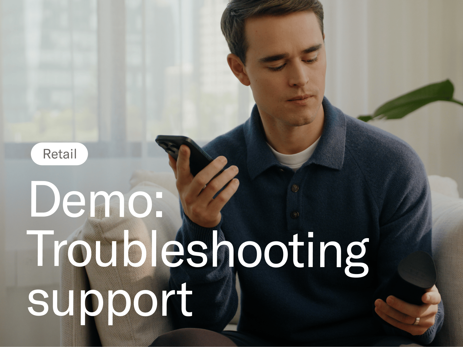 Man looking at a speaker while holding a phone. Demo: Troubleshooting support